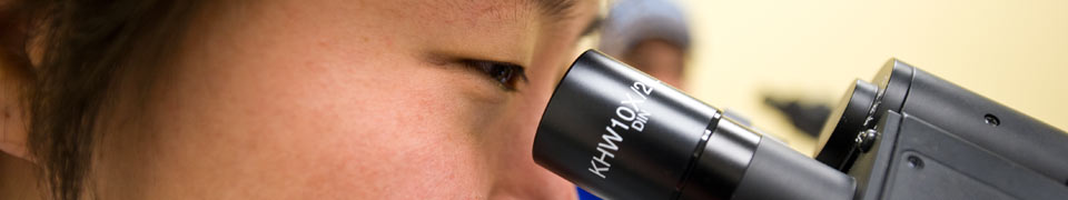photo of student and microscope