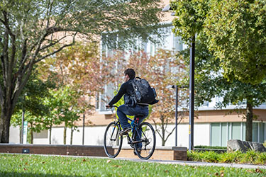 student riding bike