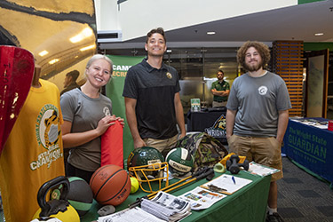 photo of campus rec staff at a table at an event