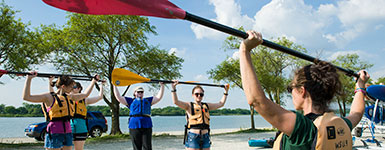 photo of students and an instructor preparing to kayak