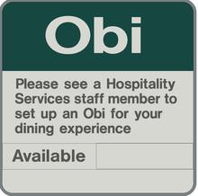 Example sign reads Obi. Please see a hospitality services staff member to set up an Obi for your dining experience. Below the words available and in use with a slider that can be changed to indicate the status.