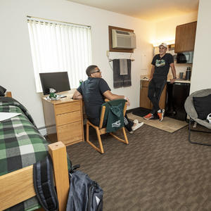 photo of two students in a dorm room