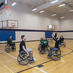 photo of students playing basketball in the student union gym