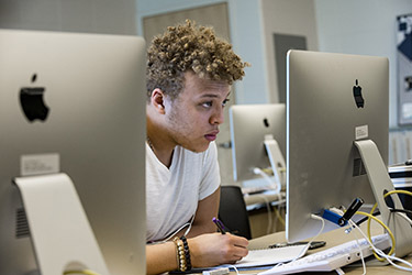 student looking at computer monitor