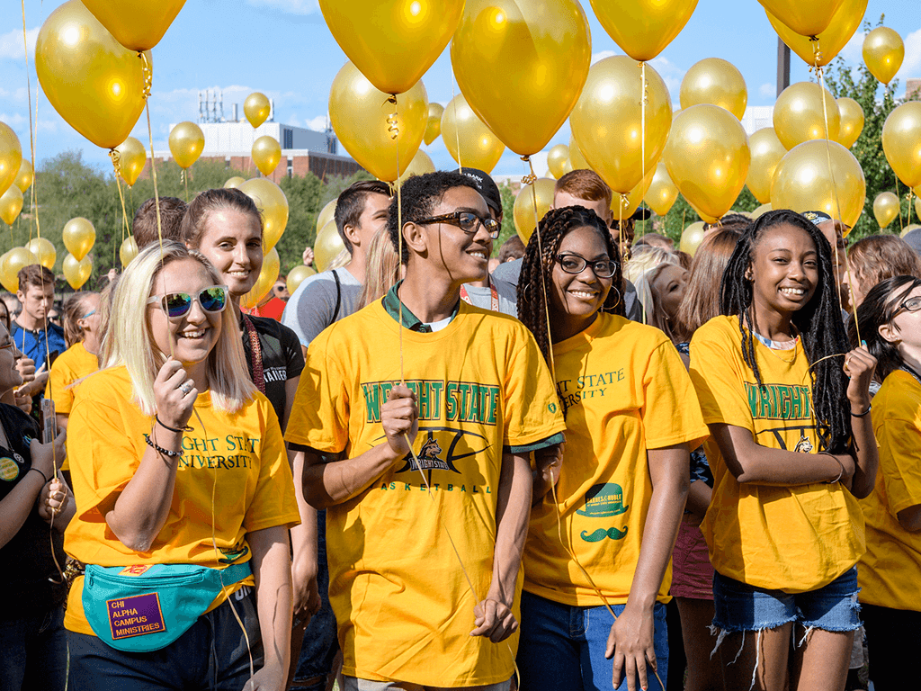 Students holding balloons in celebration of their first week at wright state university