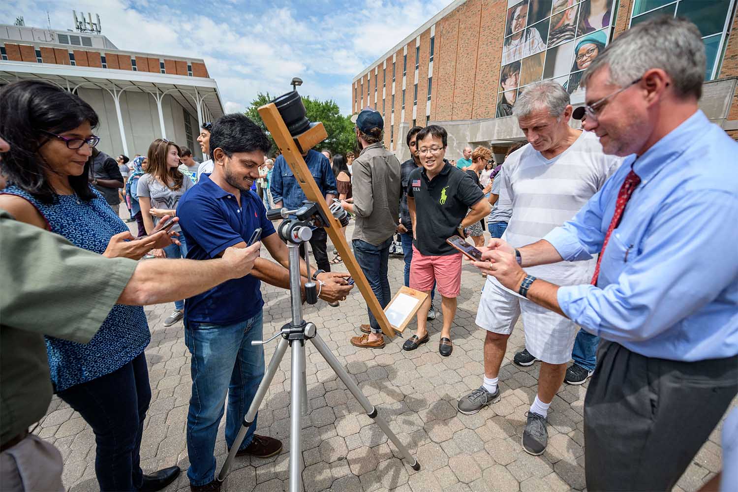 Student using a telescope in 2017 for the first solar eclipse 