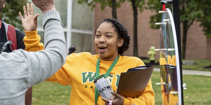 Students exchanging high fives