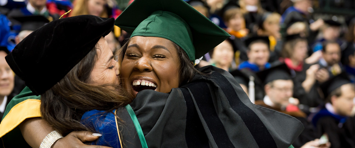 Student hugging teacher during their graduation