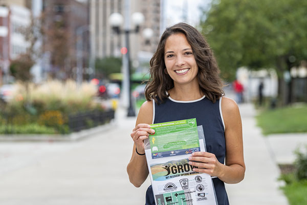 Woman handing out flyers promoting public heath