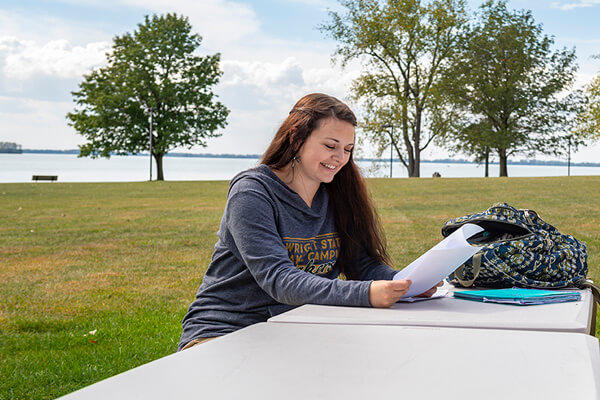 photo of a student studying outside at lake campus