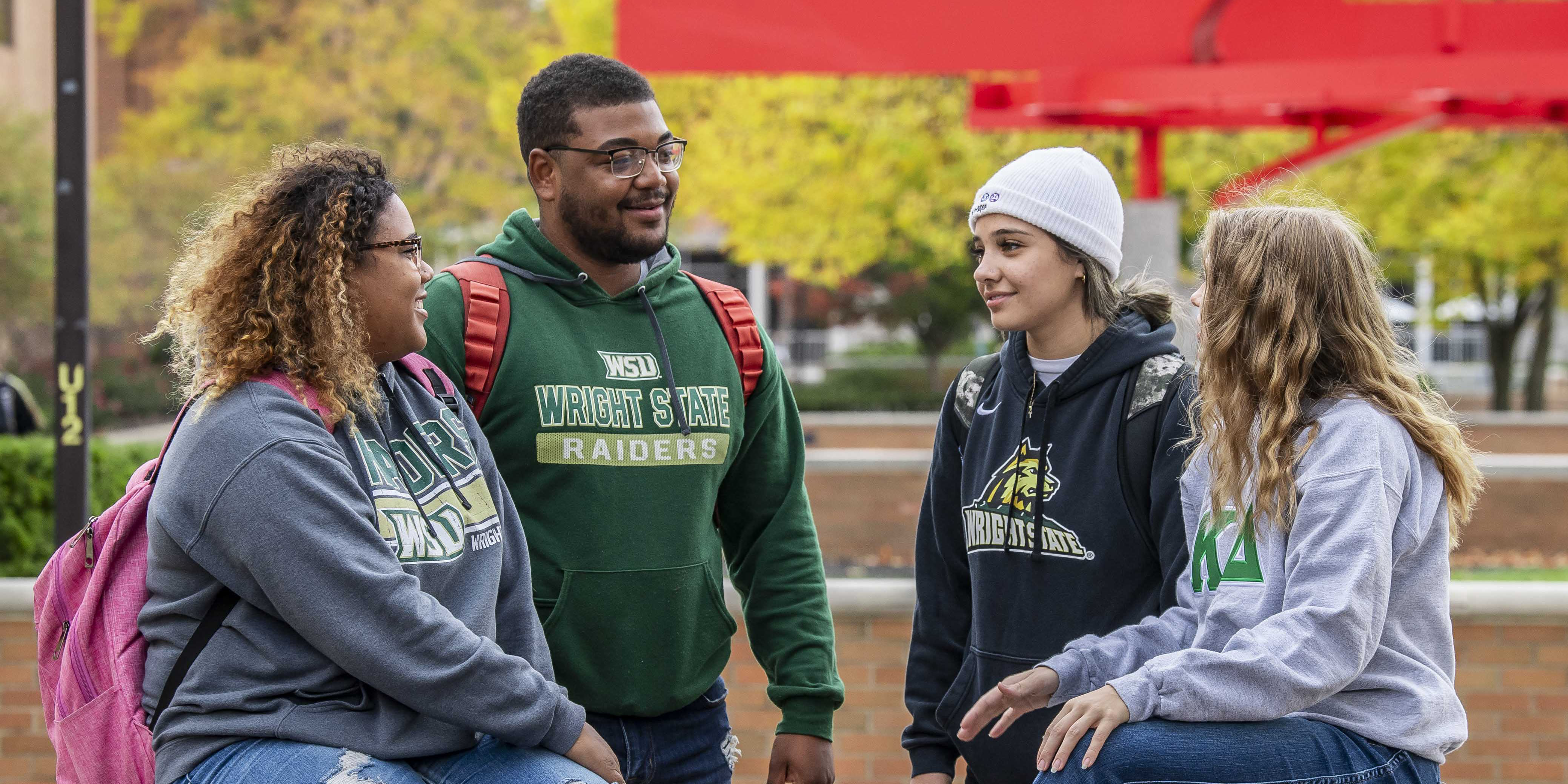 students sitting outside on campus