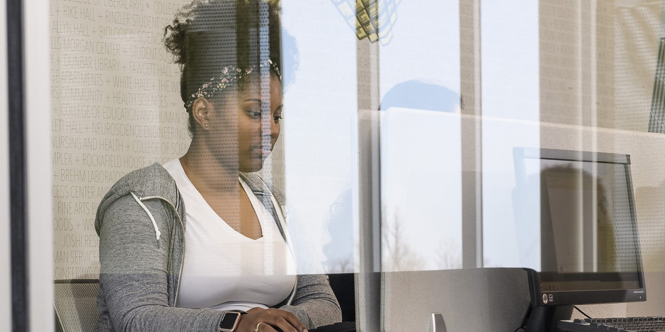 a student working at a computer in the Student Success Center at Wright State