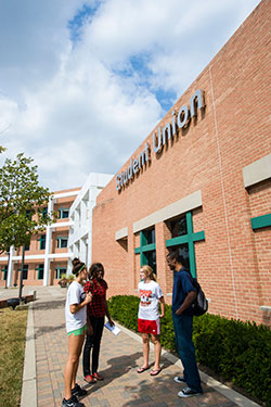 photo of students standing together outside of the student union