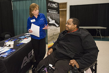 photo of a student speaking to a recruiter at a career event