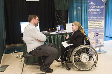 photo of a student speaking to a recruiter at a career event