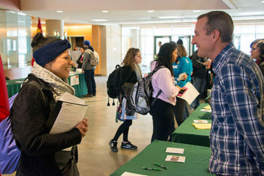 photo of a student talking to a representative at a study abroad fair