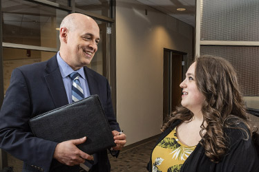 photo of a student and professor talking