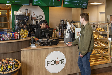 photo of a student and employee in pour cafe