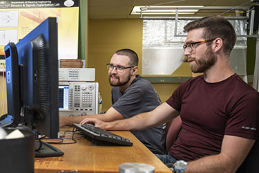 photo of two students working in a lab