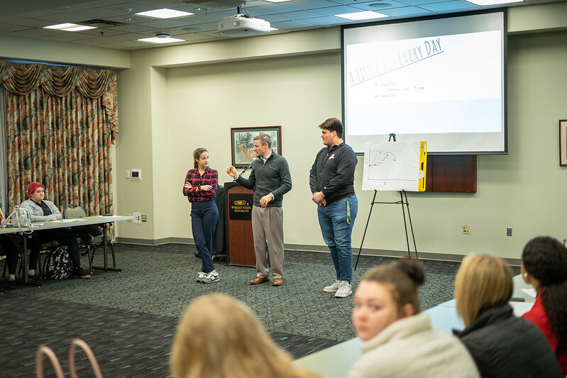 Students standing, presenting at conference