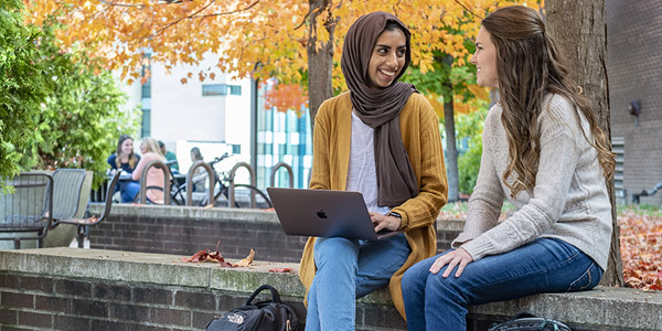 students working together outside in the fall weather