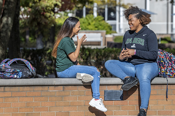 Students talking outside on campus