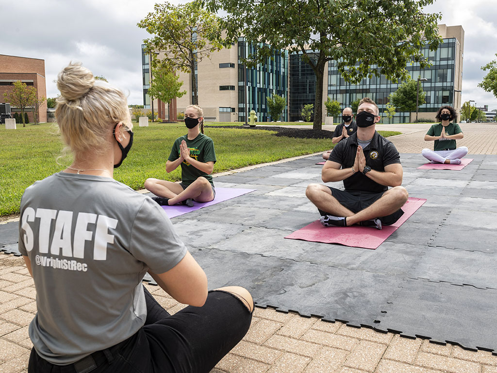 Students outside doing yoga ran by wright state university