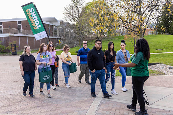 Student leading a group of families on a campus tour during Raider Open House