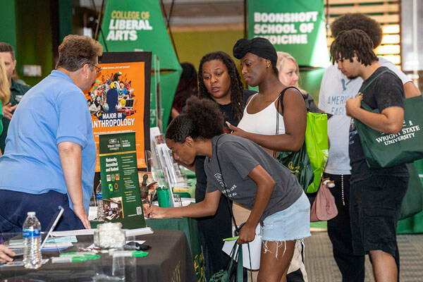 New students signing their application