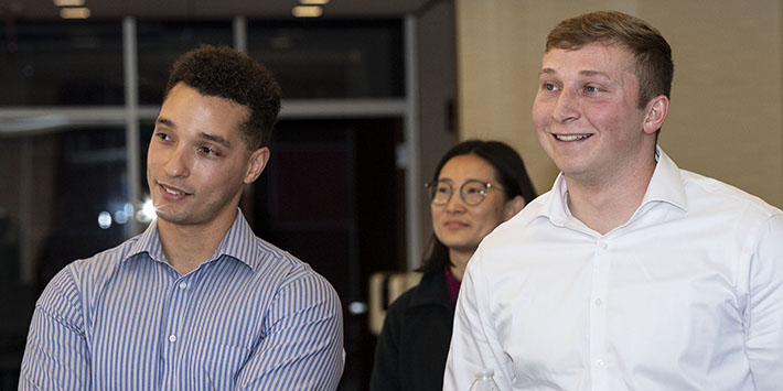 photo of three people at an event on campus