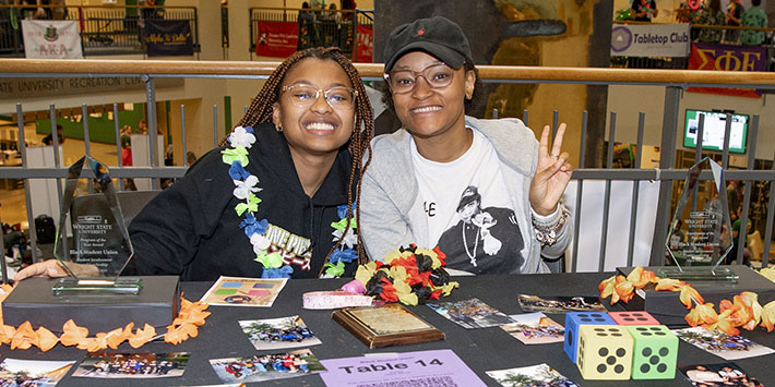 photo of two students sitting at a table at an event in the student union