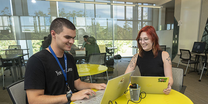 photo of a student tutoring a student in the student success center