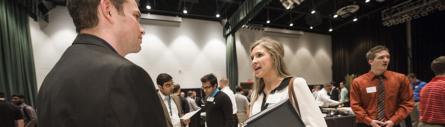 photo of a student speaking with an employer at a career fair