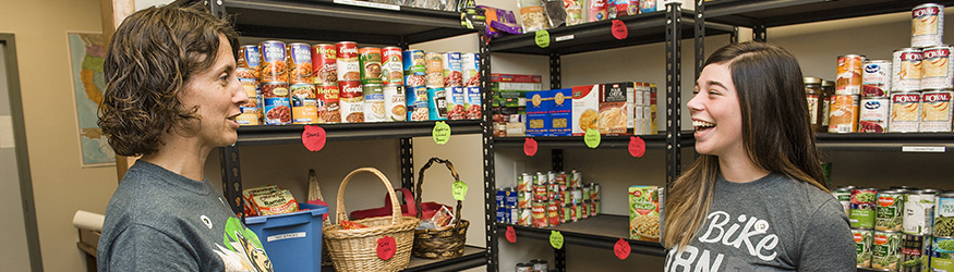 photo of a student and staff member in the food pantry
