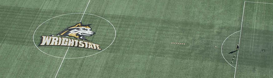 aerial photo of a soccer player and the athletics logo on the soccer field
