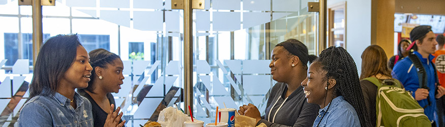 photo of students sitting at a table and eating in the student union