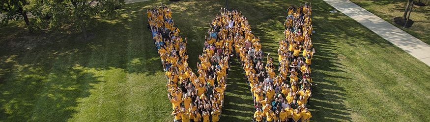 photo of people standing in the shape of w 