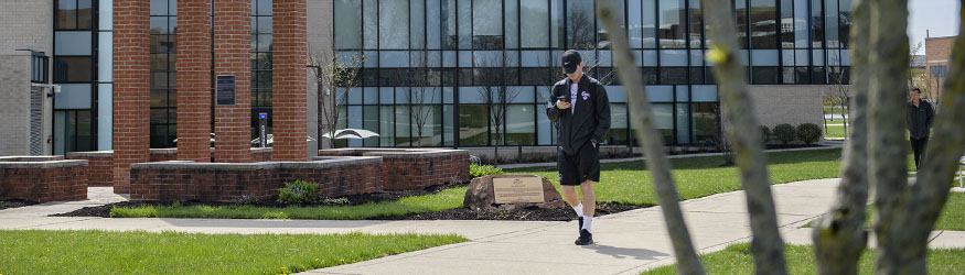 photo of a student walking on campus