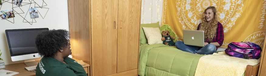 photo of two students in a dorm room in The Woods