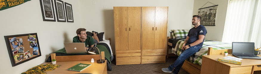 photo of two students in a dorm room in The Woods