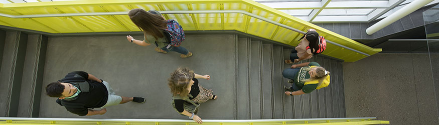 photo of students walking up and down stairs in the student success building