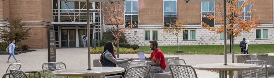 photo of students sitting outside on campus