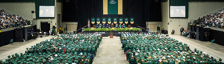 photo of graduates sitting at commencement