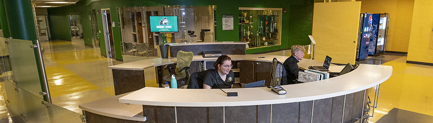 photo of two students sitting behind the recreation desk