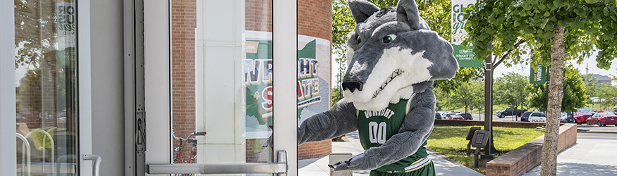 photo of rowdy holding the door open at the student union main entrance