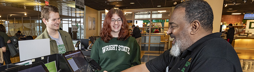 photo of two students paying for food in the union market