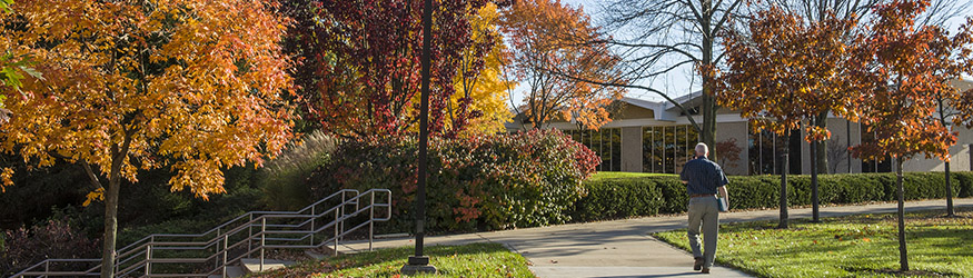 photo of an employee walking on campus