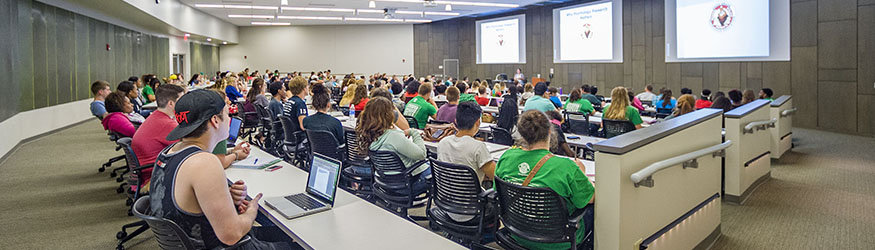 photo of students and a professor in a classroom