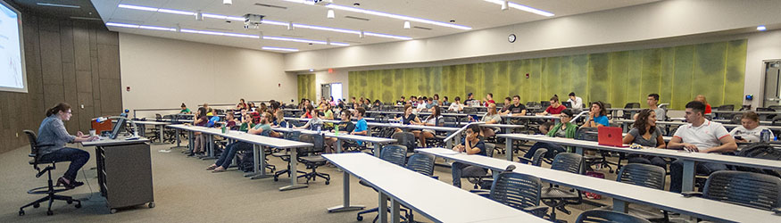 photo of students and a professor in a classroom