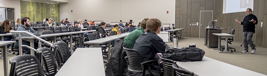 photo of students and a professor in a classroom